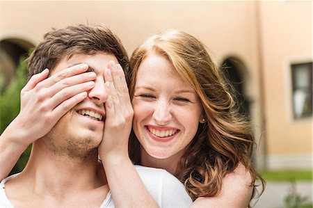 Young woman covering boyfriend's eyes Stock Photo - Premium Royalty-Free, Code: 649-07436301