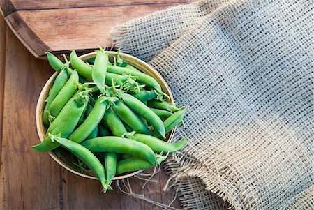 Bowl of peapods on table with burlap Stock Photo - Premium Royalty-Free, Code: 649-07436369