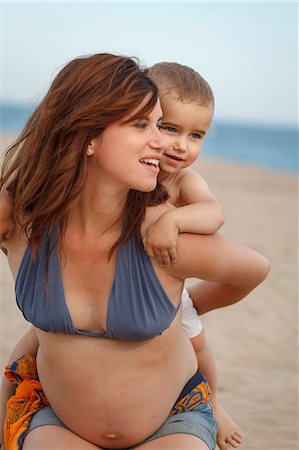 piggyback at beach - Pregnant mother giving toddler piggy back Stock Photo - Premium Royalty-Free, Code: 649-07436406