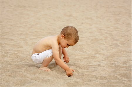 Toddler digging in sand with hand Foto de stock - Sin royalties Premium, Código: 649-07436408