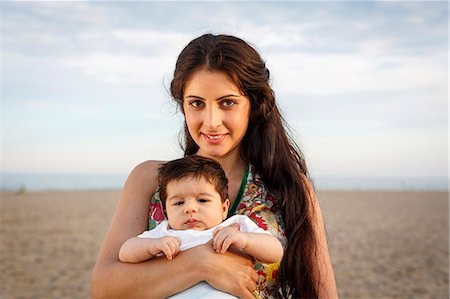 spain adult beach - Close up of mother standing on beach holding baby Stock Photo - Premium Royalty-Free, Code: 649-07436436