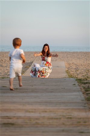 spain adult beach - Toddler running towards mother on boardwalk Stock Photo - Premium Royalty-Free, Code: 649-07436438