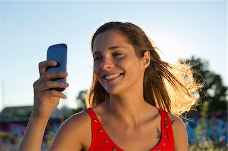 Young woman taking self portrait on mobile Stock Photo - Premium Royalty-Free, Code: 649-07436673