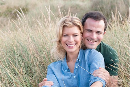 Portrait of mid adult couple in sandunes, Thurlestone, Devon, UK Stock Photo - Premium Royalty-Free, Code: 649-07436704