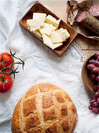 Bread, cheese, salami, grapes and tomatoes Stock Photo - Premium Royalty-Free, Code: 649-07436718