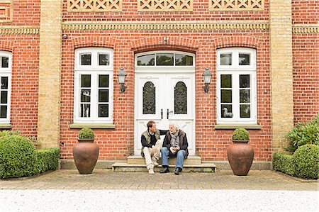 Father and son sitting on doorstep Stock Photo - Premium Royalty-Free, Code: 649-07436772