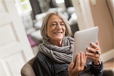 senior smiling happy alone not eye contact - Senior woman with digital tablet Stock Photo - Premium Royalty-Free, Code: 649-07436788