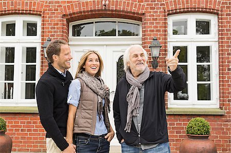 simsearch:649-07239758,k - Father and mid adult couple outside house Stock Photo - Premium Royalty-Free, Code: 649-07436795