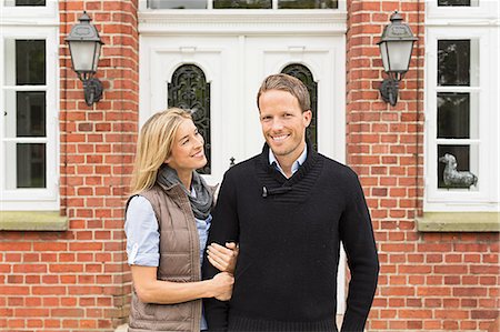 people front door - Mid adult couple outside house Stock Photo - Premium Royalty-Free, Code: 649-07436790