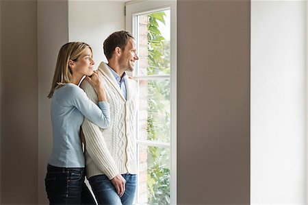 regarder par la fenêtre - Portrait of mid adult couple looking out of window Photographie de stock - Premium Libres de Droits, Code: 649-07436840