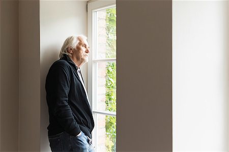 senior man introspective - Portrait of senior man looking out of window Stock Photo - Premium Royalty-Free, Code: 649-07436841