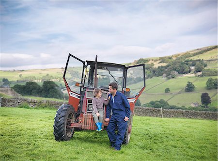 Farmer and young son sitting on tractor in field Stock Photo - Premium Royalty-Free, Code: 649-07437073