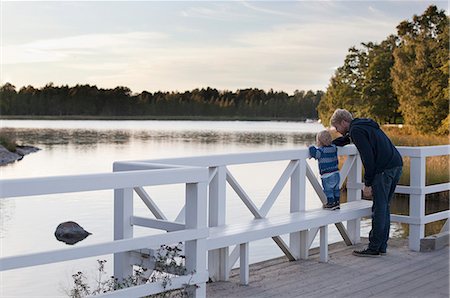 Father and son looking at lake Stock Photo - Premium Royalty-Free, Code: 649-07437106