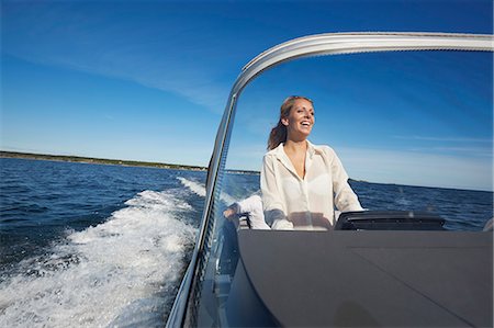 speed travel - Young woman steering boat, Gavle, Sweden Stock Photo - Premium Royalty-Free, Code: 649-07437177