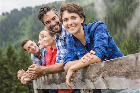 discussion group photo - Group of friends leaning on wooden fence, Tirol, Austria Stock Photo - Premium Royalty-Free, Code: 649-07437306