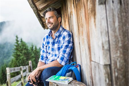 enjoy mountain view - Man enjoying the view from wooden shack, Tirol, Austria Photographie de stock - Premium Libres de Droits, Code: 649-07437322