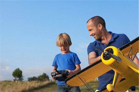 Father and son preparing model plane Stock Photo - Premium Royalty-Free, Code: 649-07437349