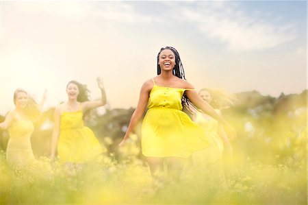 fun run - Girls in yellow dancing on meadow Stock Photo - Premium Royalty-Free, Code: 649-07437433