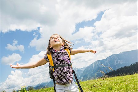 smiling looking up - Young girl with arms out, Tyrol, Austria Stock Photo - Premium Royalty-Free, Code: 649-07437564