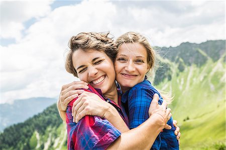 friends summer outdoor - Two female friends hugging, Tyrol, Austria Stock Photo - Premium Royalty-Free, Code: 649-07437573