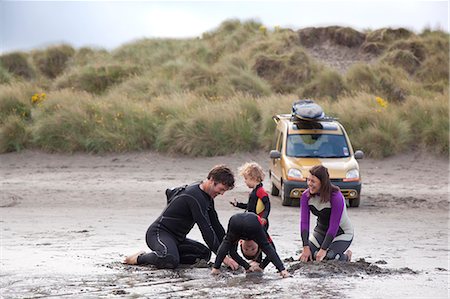 surfer male adult middle aged - Family with two boys playing on beach Stock Photo - Premium Royalty-Free, Code: 649-07437679