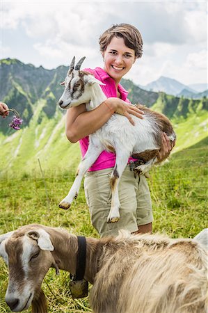 Young woman holding kid goat, Tyrol, Austria Foto de stock - Sin royalties Premium, Código: 649-07437721