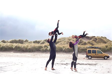 diving suit - Parents lifting sons on beach Stock Photo - Premium Royalty-Free, Code: 649-07437733