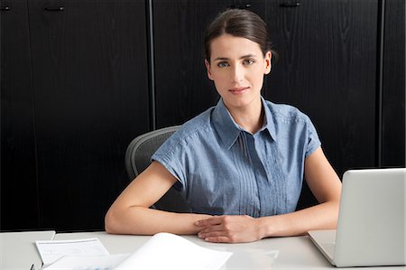 Businesswoman using laptop Stock Photo - Premium Royalty-Free, Code: 649-07437796