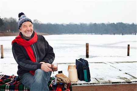 drinking hot drink outside - Man sitting on pier having hot drink Stock Photo - Premium Royalty-Free, Code: 649-07437998