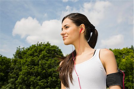 Jogger listening to mp3 player with earphones Stock Photo - Premium Royalty-Free, Code: 649-07438065