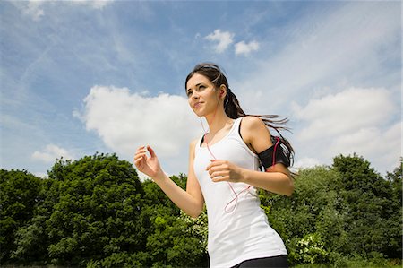 determined female jogger - Jogger listening to mp3 player with earphones Stock Photo - Premium Royalty-Free, Code: 649-07438066