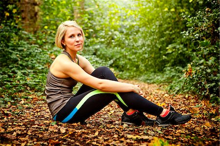 Woman sitting on ground in woods Stock Photo - Premium Royalty-Free, Code: 649-07520089