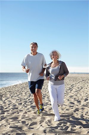 senior man exercising - Couple jogging on beach Stock Photo - Premium Royalty-Free, Code: 649-07520148
