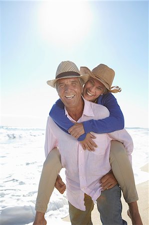 seniors vacation - Man piggy-backing woman on beach Stock Photo - Premium Royalty-Free, Code: 649-07520163