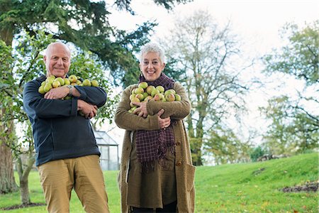 farmer and happy - Happy senior couple with armful of apples Stock Photo - Premium Royalty-Free, Code: 649-07520208