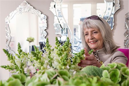 senior happy luxury - Senior woman looking at flowers in florist shop Stock Photo - Premium Royalty-Free, Code: 649-07520289