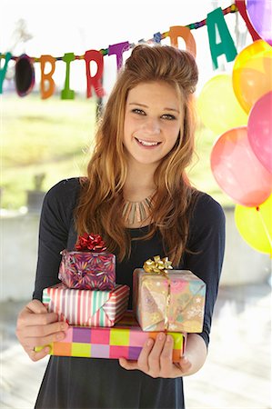 picture of a girl celebrating her birthday - Portrait of  teenage girl holding birthday gifts Stock Photo - Premium Royalty-Free, Code: 649-07520280