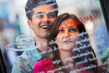 simsearch:614-07444091,k - Young couple reading cafe window menu, Paris, France Stock Photo - Premium Royalty-Free, Code: 649-07520317