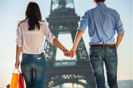 sunlight jeans - Young couple strolling in front of  Eiffel Tower, Paris, France Stock Photo - Premium Royalty-Free, Code: 649-07520329