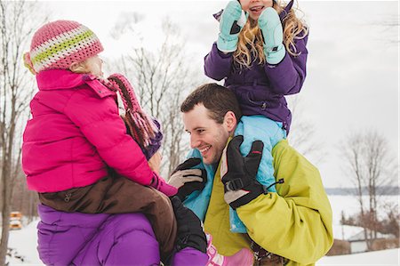 family photos in winter - Mother and father carrying daughters in snow Stock Photo - Premium Royalty-Free, Code: 649-07520407