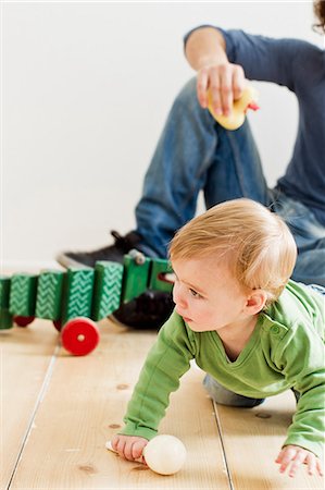 denim jeans for kids - Studio shot of father and baby daughter playing on floor Stock Photo - Premium Royalty-Free, Code: 649-07520626