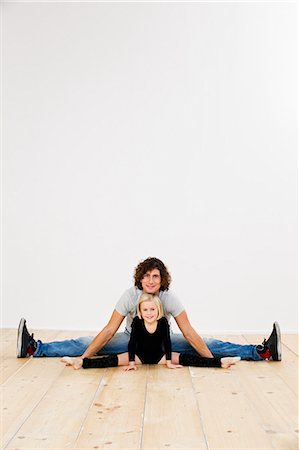 Studio portrait of father and ballerina daughter doing splits Stock Photo - Premium Royalty-Free, Code: 649-07520622