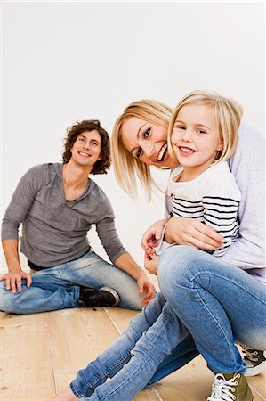 delighted people white background - Studio shot of couple with daughter Stock Photo - Premium Royalty-Free, Code: 649-07520642
