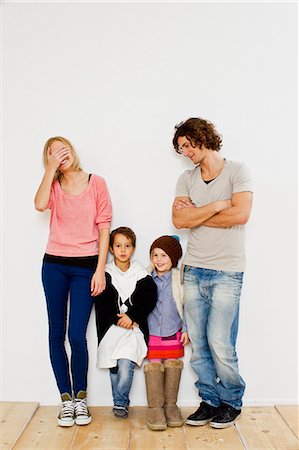 future - Studio shot of couple with son and daughter in oversize clothes Stock Photo - Premium Royalty-Free, Code: 649-07520654