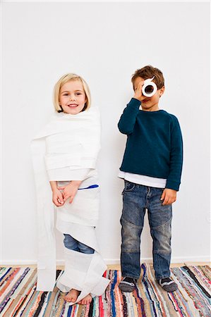disguise - Studio shot of sister and brother with toilet rolls Stock Photo - Premium Royalty-Free, Code: 649-07520671