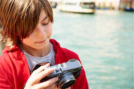 Young boy checking photographs on camera,Venice, Italy Stock Photo - Premium Royalty-Free, Code: 649-07520750