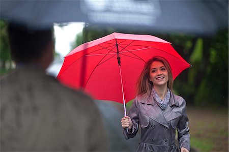 person and raincoat and umbrella - Young woman meeting man in park Stock Photo - Premium Royalty-Free, Code: 649-07520866