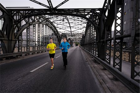 Two men running over city bridge Stock Photo - Premium Royalty-Free, Code: 649-07520906