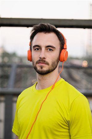 standing, headphones - Portrait of young male runner wearing headphones Stock Photo - Premium Royalty-Free, Code: 649-07520908