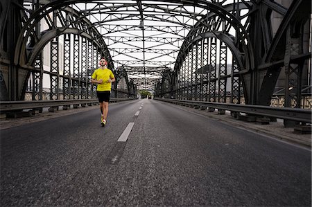 fit person running - Young male athlete running on bridge Stock Photo - Premium Royalty-Free, Code: 649-07520910